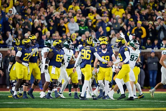 Dominic Zvada (96) and Michigan Team
