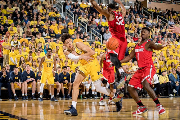 D.J. Wilson (5) and Derrick Walton Jr. (10)