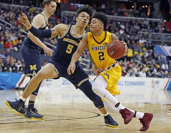 Mark Donnal (34) and D.J. Wilson (5)