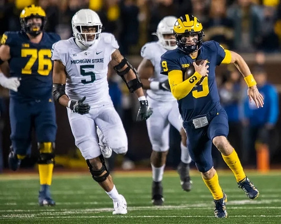 Ryan Hayes (76) and J.J. McCarthy (9)