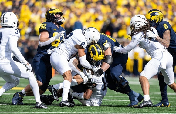 Max Bredeson (82), Blake Corum (2), Zak Zinter (65), and Ronnie Bell (8)