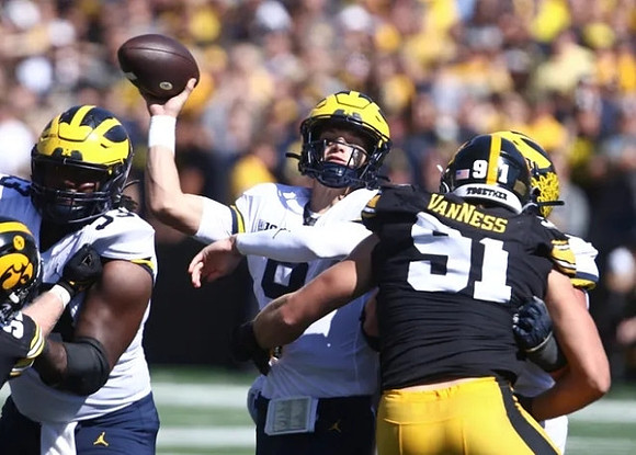 Trente Jones (53) and J.J. McCarthy (9)