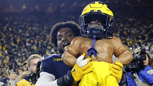 Josaiah Stewart (0) and Paul Bunyan Trophy