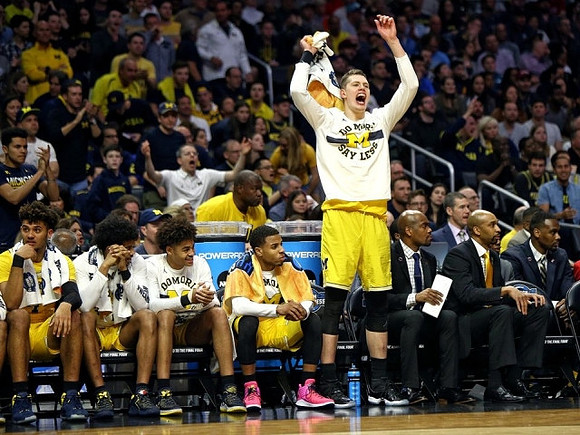 Moritz Wagner (13) and Michigan Team