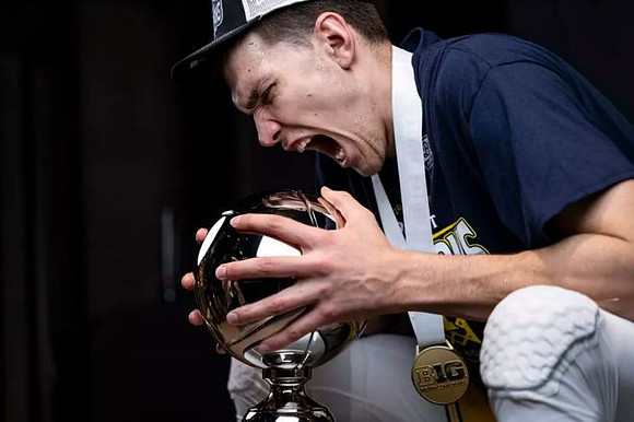 Vladislav Goldin (50) and Big Ten Tournament Championship Trophy