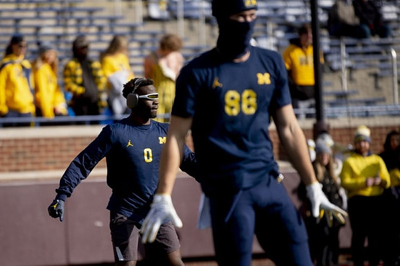 Mike Sainristil (0) and Matthew Hibner (88)