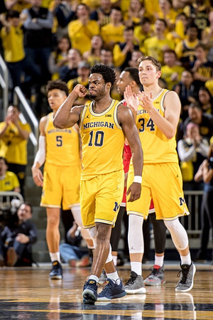 D.J. Wilson (5), Derrick Walton Jr. (10), and Mark Donnal (34)