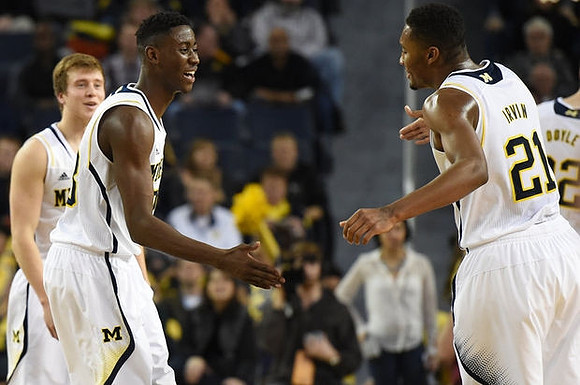 Spike Albrecht (2), Caris LeVert (23), and Zak Irvin (21)