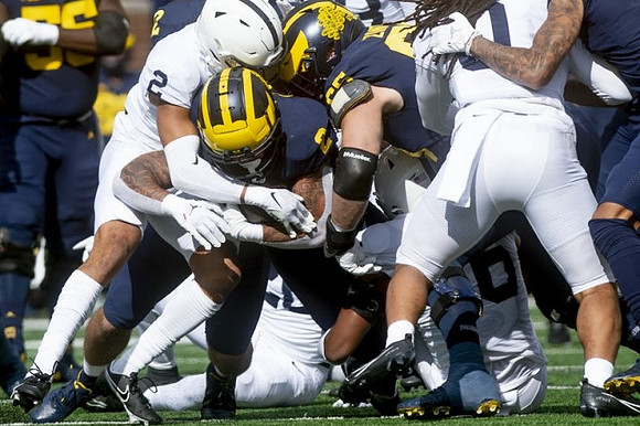 Olusegun Oluwatimi (55), Blake Corum (2), and Zak Zinter (65)
