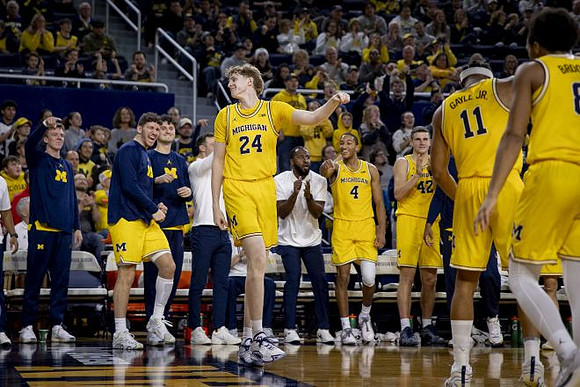 Sam Walters (24) and Michigan Team