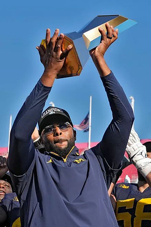 Sherrone Moore and ReliaQuest Bowl Trophy