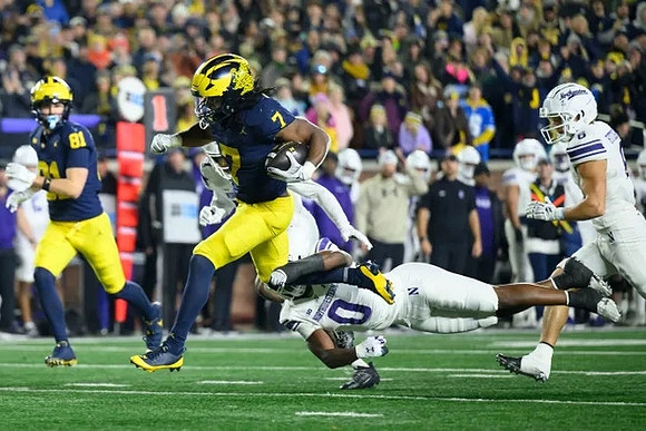 Peyton O'Leary (81) and Donovan Edwards (7)