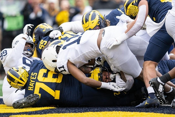 Ryan Hayes (76), Olusegun Oluwatimi (55), and Blake Corum (2)
