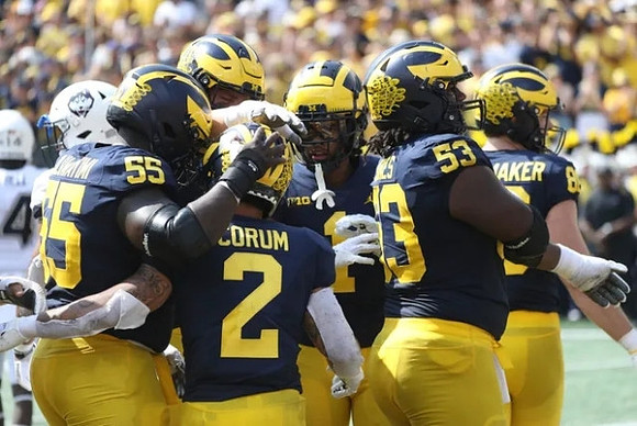 Olusegun Oluwatimi (55), Blake Corum (2), Andrel Anthony (1), Trente Jones (53), and Luke Schoonmaker (86)