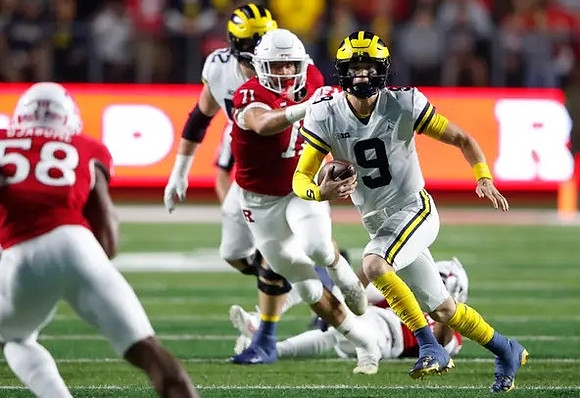 J.J. McCarthy (9) and Karsen Barnhart (52)
