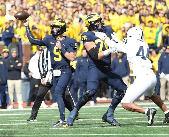 J.J. McCarthy (9) and Ryan Hayes (76)