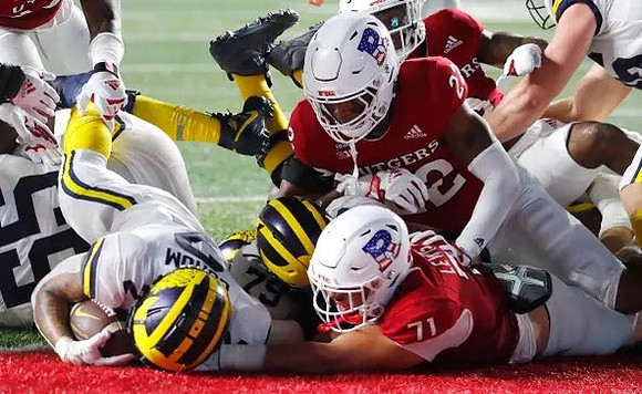 Jeffrey Persi (79), Blake Corum (2), and Olusegun Oluwatimi (55)