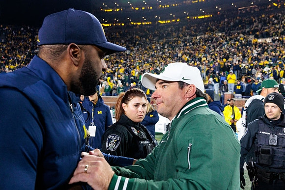 Sherrone Moore and Michigan State Head Coach Jonathan Smith