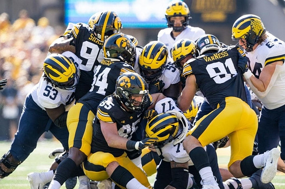 Trente Jones (53), Trevor Keegan (77), Olusegun Oluwatimi (55), J.J. McCarthy (9), and Joel Honigford (84)