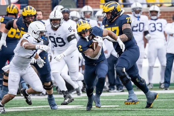 Blake Corum (2) and Trevor Keegan (77)