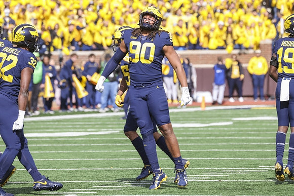 Jaylen Harrell (32), Mike Morris (90), and Rod Moore (19)