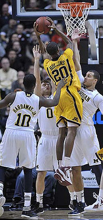 Tim Hardaway Jr. (10), Zack Novak (0), and Evan Smotrycz (23)