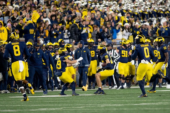 Mason Curtis (25) and Michigan Team