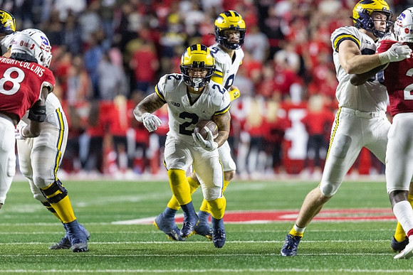 Blake Corum (2), J.J. McCarthy (9), and Luke Schoonmaker (86)