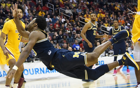 Derrick Walton Jr. (10), Zak Irvin (21), and Muhammad-Ali Abdur-Rahkman (12)
