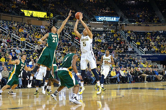 D.J. Wilson (5) and Zak Irvin (21)