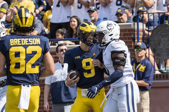 Max Bredeson (82) and J.J. McCarthy (9)
