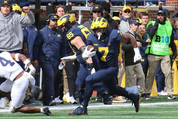 Zak Zinter (65) and Donovan Edwards (7)