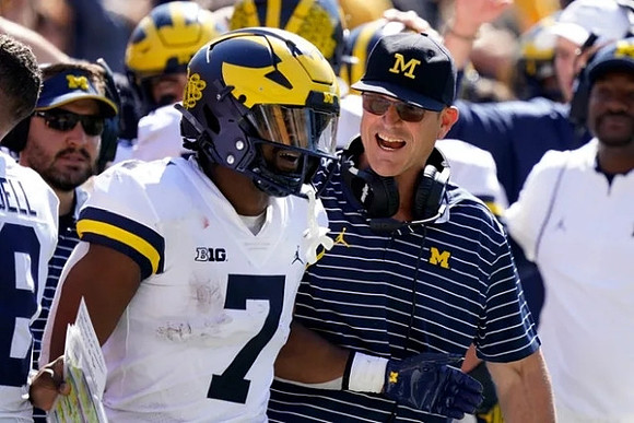 Donovan Edwards (7) and Jim Harbaugh