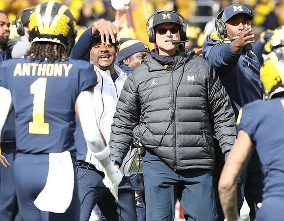 Andrel Anthony (1) and Jim Harbaugh