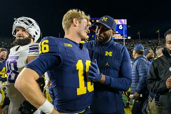 Davis Warren (16) and Sherrone Moore