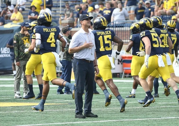 Micah Pollard (4), Jim Harbaugh, Deuce Spurlock (15), and Trevor Andrews (57)