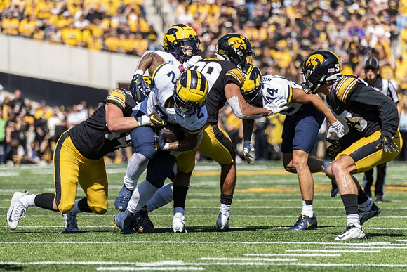 Blake Corum (2) and Roman Wilson (14)