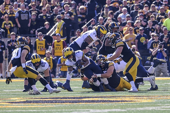 Zak Zinter (65), Blake Corum (2), and Trevor Keegan (77)
