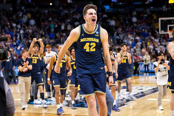 Will Tschetter (42) and Michigan Team