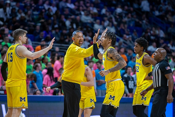 Joey Baker (15), Juwan Howard, Dug McDaniel (0), and Tarris Reed Jr. (32)