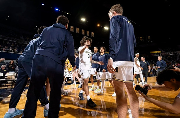 Tre Donaldson (3) and Michigan Team