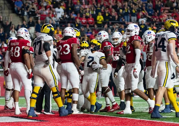 Trevor Keegan (77), Blake Corum (2), and Joel Honigford (84)