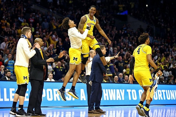 Moritz Wagner (13), Saddi Washington, Jordan Poole (2), Charles Matthews (1), John Beilein, Luke Yaklich, and Isaiah Livers (4)
