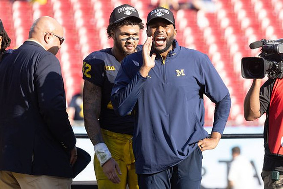 TJ Guy (42) and Sherrone Moore