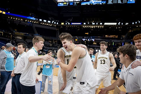 Will Tschetter (42) and Michigan Team