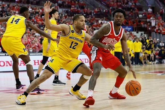 DeVante' Jones (12), Moussa Diabate (14), and Brandon Johns Jr. (23)