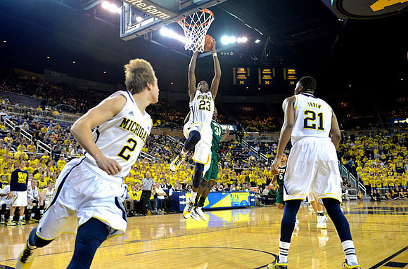 Spike Albrecht (2), Caris LeVert (23), and Zak Irvin (21)