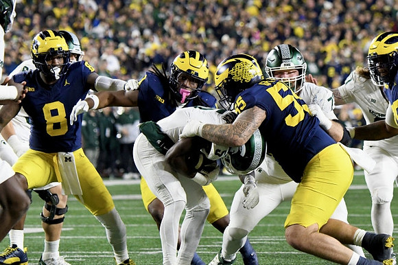 Derrick Moore (8), Mason Graham (55), and Jaishawn Barham (1)