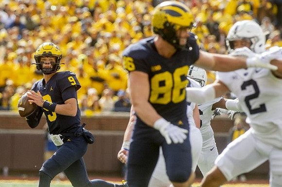 J.J. McCarthy (9) and Luke Schoonmaker (86)