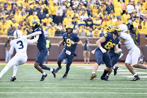 Andrel Anthony (1), J.J. McCarthy (9), and Luke Schoonmaker (86)